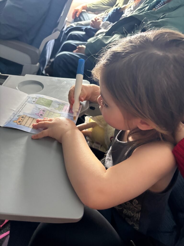 Toddler on a plane enjoying activity books
